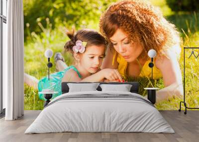 mother and child in the park enjoying a sunny day Wall mural