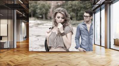 sexy and fashionable couple wearing jeans, grungy location Wall mural