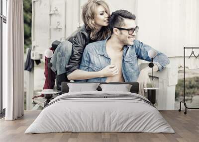 stylish couple wearing jeans and boots smiling Wall mural