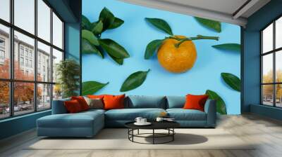 orange or Citrus sp with leaves isolated on blue background Wall mural