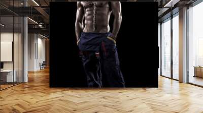 muscled man on a black background Wall mural