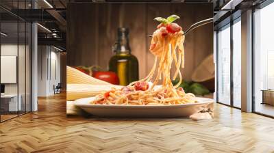 spaghetti with amatriciana sauce in the dish on the wooden table Wall mural