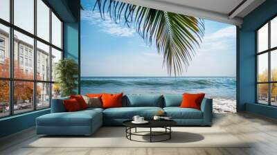 The coconut tree leaves with background with sea waves on the beach for mockup background. Tropical sea beach template and palm leaf on seaside Wall mural