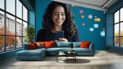 A smiling woman engages with her smartphone, surrounded by colorful social media icons against a blue background. Wall mural