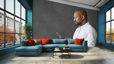 African American businessman using a digital tablet by a chalkboard Wall mural