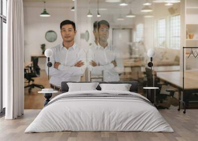 Asian businessman leaning against a glass wall in an office Wall mural