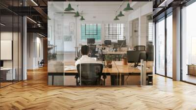 Businessman working alone at a desk in an office Wall mural