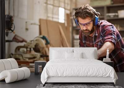 Carpenter working with machinery cutting a wooden plank Wall mural