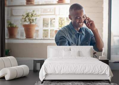 handsome young african entrepreneur smiling and talking on mobile Wall mural