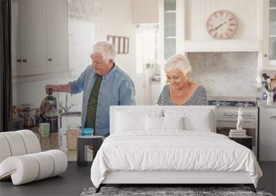 Happy senior couple preaparing a healthy breakfast in their kitchen Wall mural