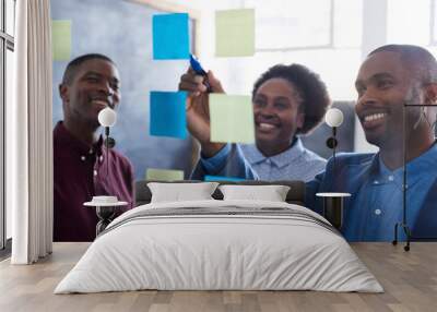 positive african work colleagues brainstorming together in an office Wall mural