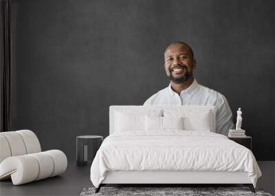 Smiling African American businessman using a tablet by a chalkboard Wall mural