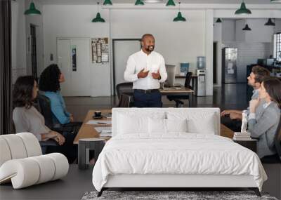 Smiling African American manager meeting with his office staff Wall mural