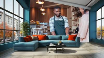 Smiling barista using nfc technology for a customer's payment Wall mural