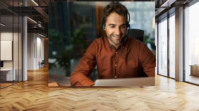 Smiling businessman talking on a headset with a client Wall mural