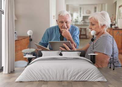 Smiling seniors talking and using digital tablets together over breakfast Wall mural