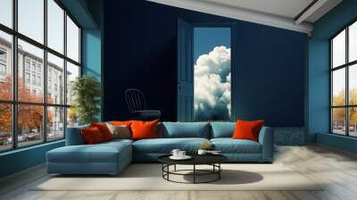 Open door with view of clouds and grassy field in dark room with chair. Wall mural