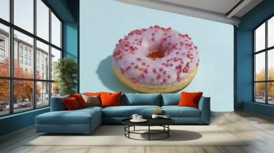 appetizing fresh doughnut on a blue background Wall mural