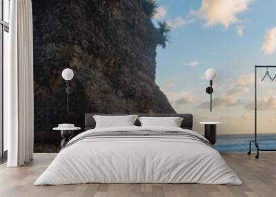 A beautiful beach with boulder and white sands in the afternoon. Wall mural