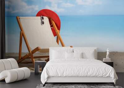 Beach deck chair on a sandy beach by the sea. Summer mood. Space to copy Wall mural