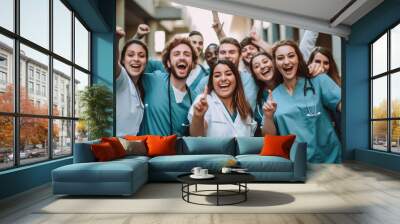 Celebrating medical education: Diverse team of students wearing nurse uniform cheers for joy Wall mural