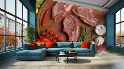 Raw pork steak on a wooden board. composition of various cooking products. Top view. Wall mural