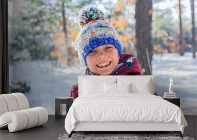 Boy playing in big snow in winter. Wall mural