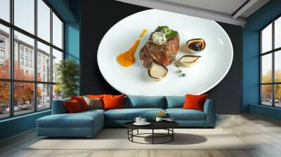 traditional dishes of European cuisine, delicacy, banquet snack. culinary dishes on a white plate on a black background. restaurant service Wall mural