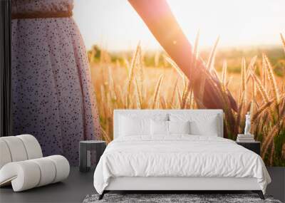 beautiful girl in stylish summer dress walking in the field with flowers in sunlight,enjoying freedo Wall mural