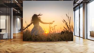 Trendy girl in stylish summer dress feeling free in the field with flowers in sunshine,enjoying nature, Beautiful Teenage Model in the Spring Field, Sun Light. Wall mural