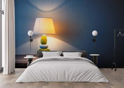 Little yellow, gray and green lamp on a wooden dresser or a night table, illuminating the wall covered with wallpaper at night or late evening. Soft and warm interior mood. Wall mural