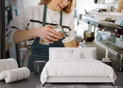 Barista holding cup getting fresh coffee that being brewed by the machine in cafe. Professional coffee brewing. Wall mural