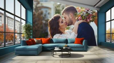 Beautiful Bride and Groom enjoy each other. happy romantic young couple celebrating their marriage. Sexy kissing stylish couple of lovers close up portrait. wedding concept. Wall mural