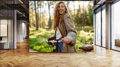 Beautiful woman  riding bicycle in  park. Lifestyle. Relax, nature concept. Spring time. Wall mural