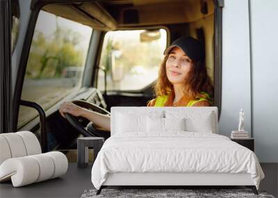 Female driver looking out of truck window. Transport industry theme Wall mural