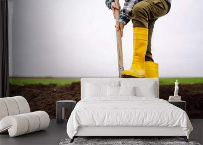 Female Worker digs soil with shovel in the vegetable garden. Agriculture and tough work concept Wall mural