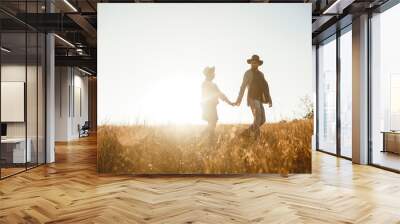 Follow me. Men leads the girl behind him. Lovely hipster couple . Couple wearing beautiful hats and sweaters. Lifestyle, happy couple of two play on a sunny day in the park.  Sunset in autumn. Wall mural