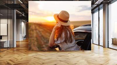 Relaxed happy woman on summer road trip travel vacation leaning out car window. Lifestyle, travel, tourism, nature, active life. Wall mural