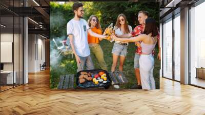 Сompany of people having bbq party on in summer park. Friends grill meat, have fun, relax. Сoncept of lifestyle, holidays, weekends and leisure. Picnic and barbecue. Wall mural