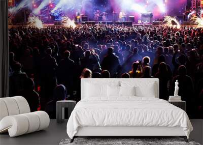 silhouettes of concert crowd in front of bright stage lights. Wall mural