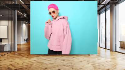 Fashion portrait of young hipster woman in pink hoody. Short pink hair Wall mural