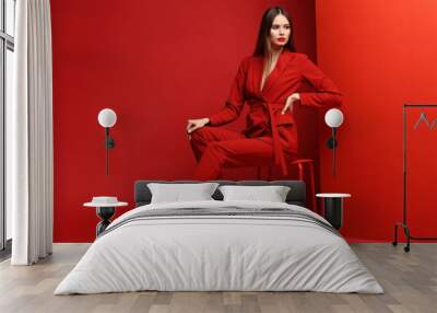 Fashion young woman in red suit. Wall mural