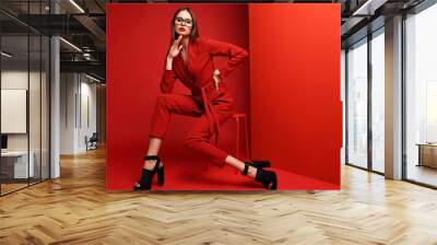 Fashion young woman in red suit. Wall mural