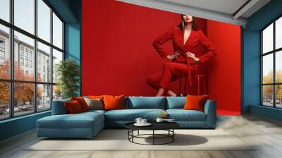 Fashion young woman in red suit. Wall mural