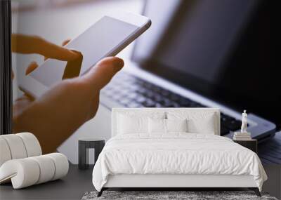 Woman's hands using mobile phone at the office Wall mural