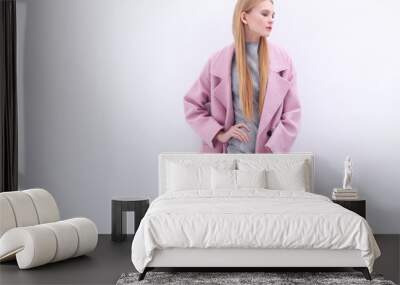 Young elegant woman in trendy pink coat. Wall mural