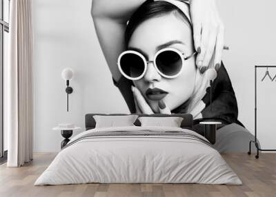 Young woman in retro style. Sunglasses and silk scarf. Wall mural