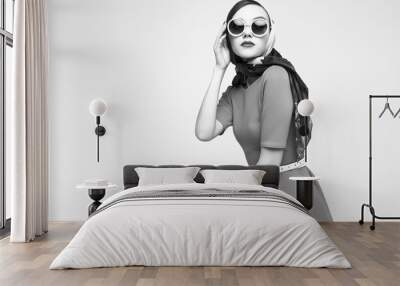 Young woman in retro style. Sunglasses and silk scarf. Wall mural