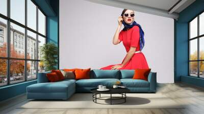 Young woman in retro style. Sunglasses and silk scarf. Wall mural