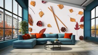 Autumn background: autumn leaves and asian chopsticks hold pinecone. Top view, flat lay. Wall mural